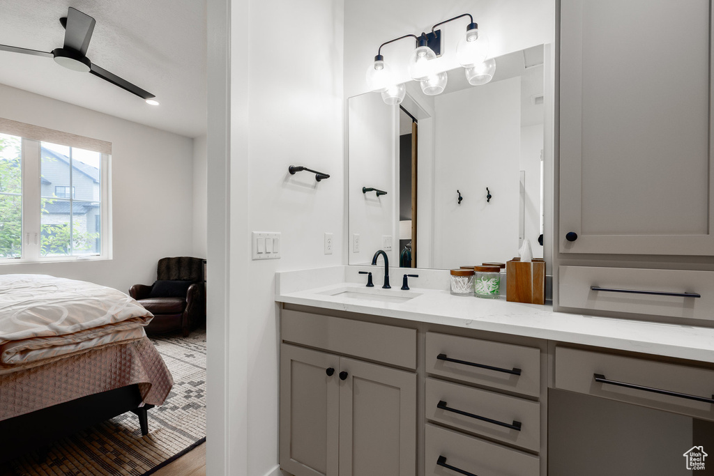 Bathroom with double vanity, connected bathroom, and a ceiling fan