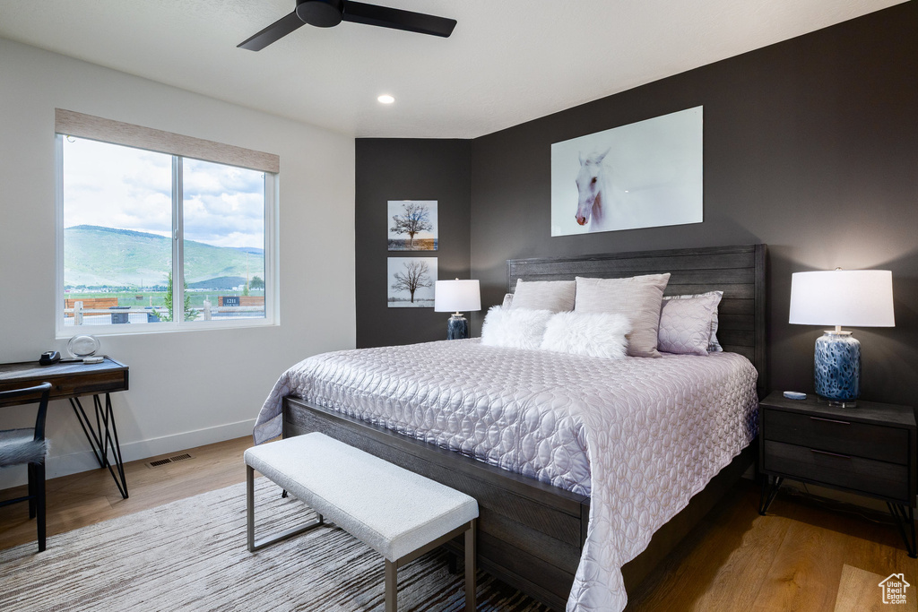 Bedroom featuring wood finished floors, recessed lighting, baseboards, and a ceiling fan