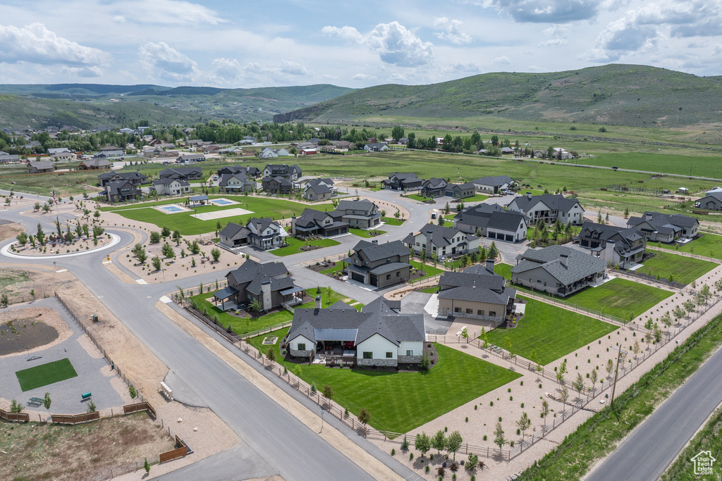 Aerial perspective of suburban area featuring a mountainous background