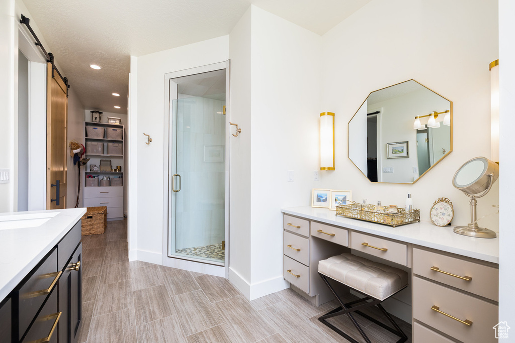 Full bathroom with vanity, a stall shower, baseboards, recessed lighting, and wood tiled floors