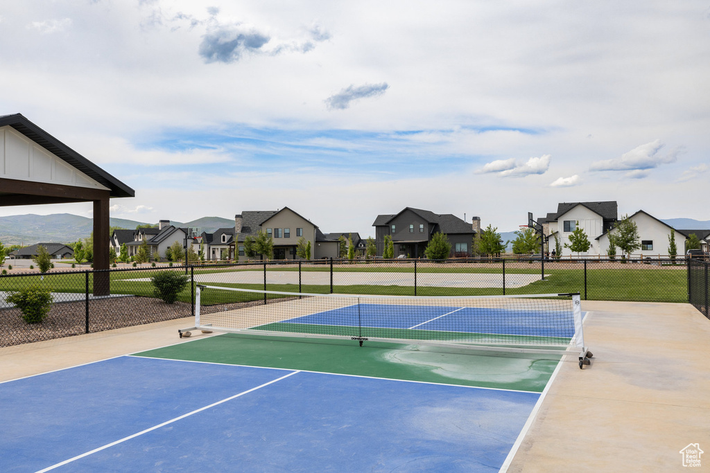 View of community featuring a residential view and a tennis court