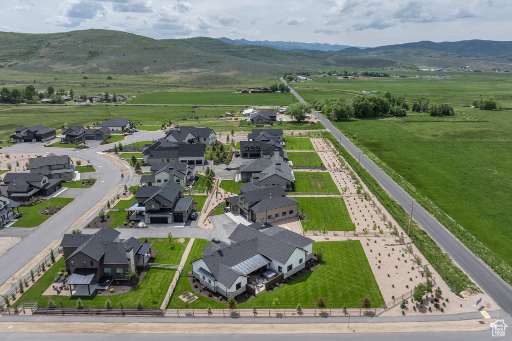 Aerial view of sparsely populated area featuring a mountain backdrop and nearby suburban area