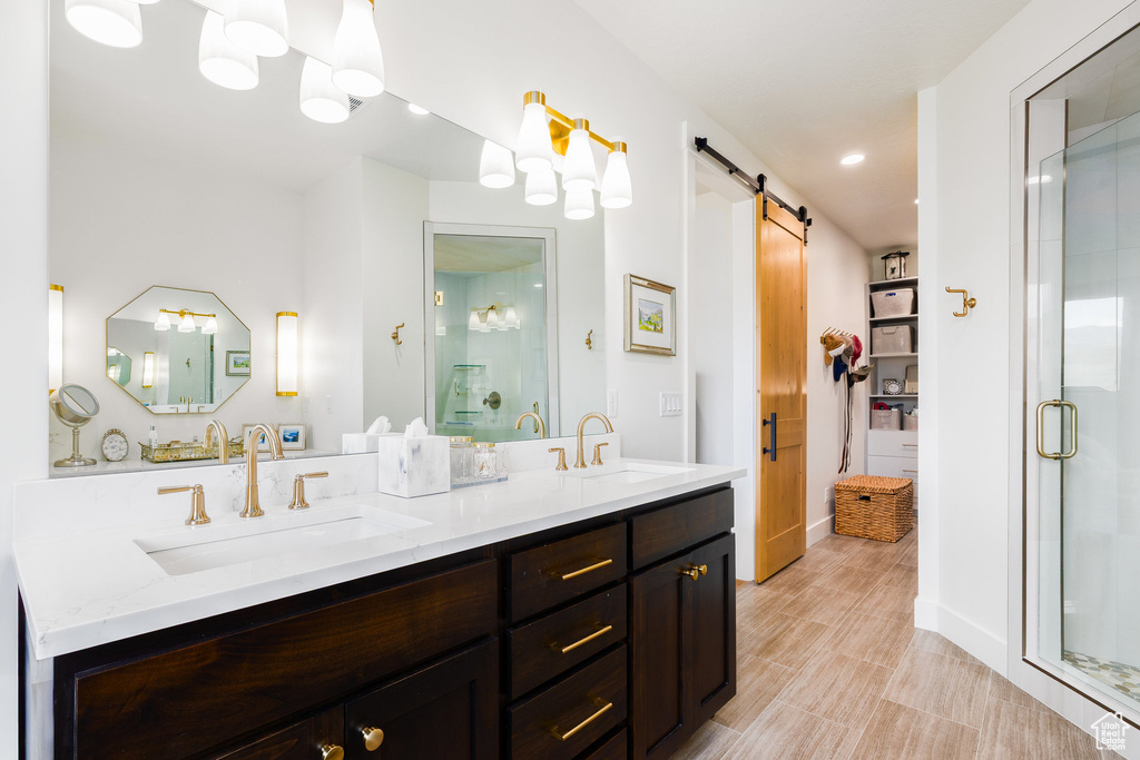 Bathroom featuring double vanity, a stall shower, and recessed lighting
