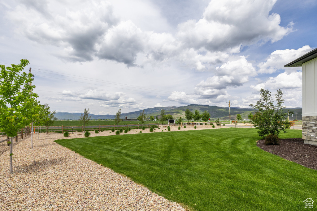 View of yard with a rural view and a mountain view