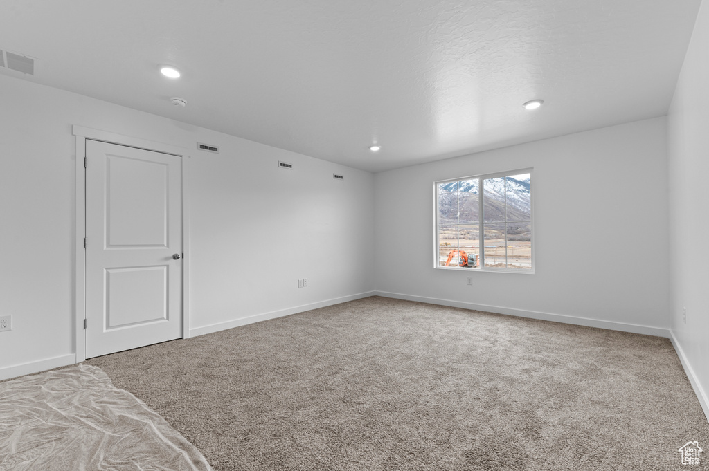 Unfurnished bedroom with carpet floors, baseboards, and recessed lighting