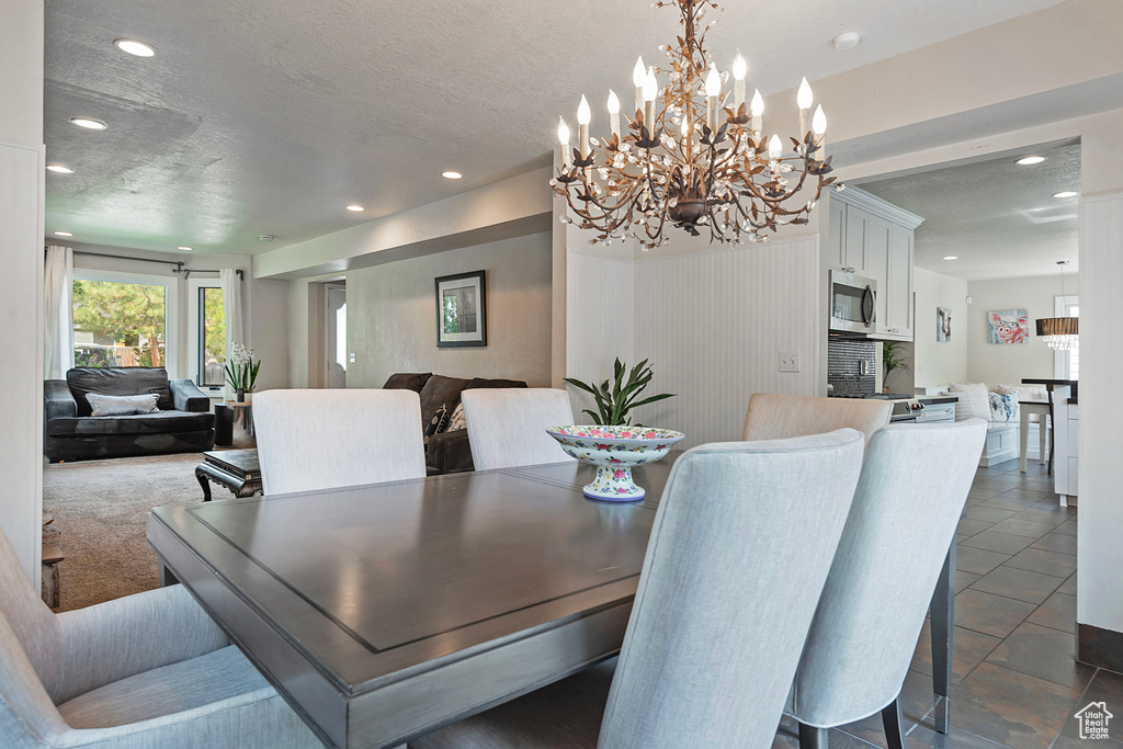 Dining space with recessed lighting, a textured ceiling, and a chandelier