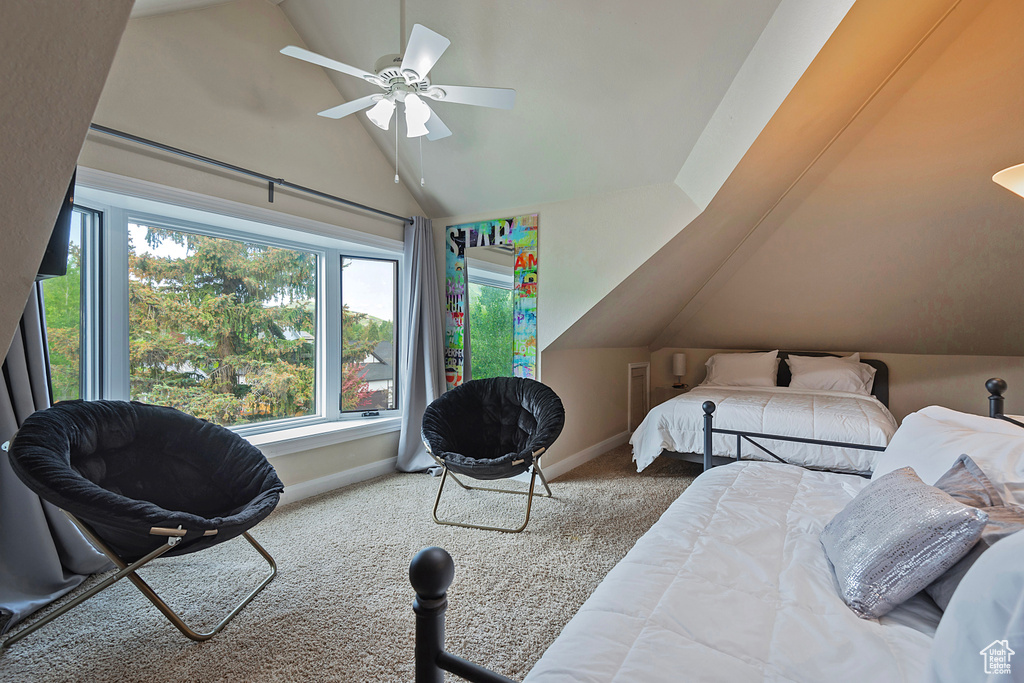 Bedroom featuring lofted ceiling, carpet flooring, baseboards, and a ceiling fan