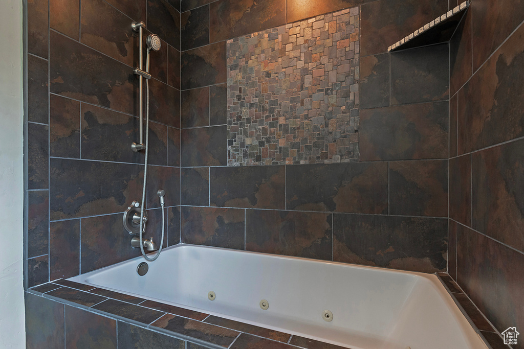 Bathroom featuring a combined bath / shower with jetted tub
