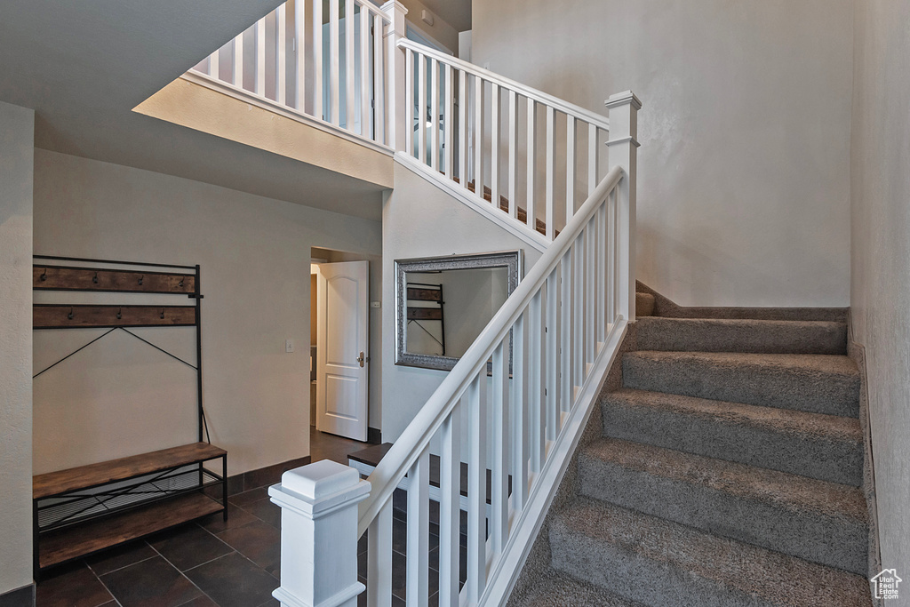 Stairs featuring tile patterned flooring