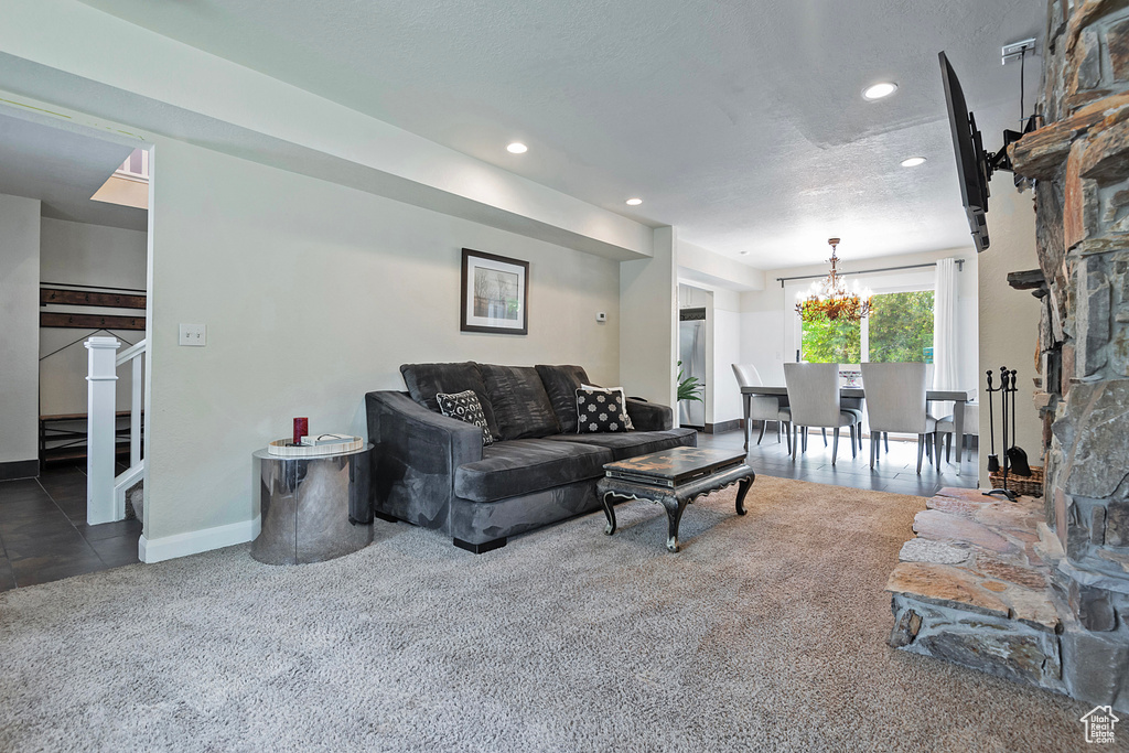 Living room featuring carpet flooring, a chandelier, recessed lighting, baseboards, and stairway