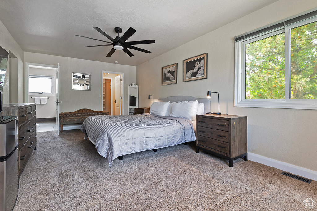 Bedroom featuring carpet floors, baseboards, and a ceiling fan