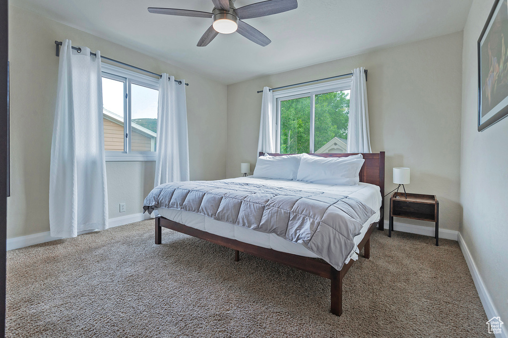 Bedroom featuring carpet, baseboards, and ceiling fan