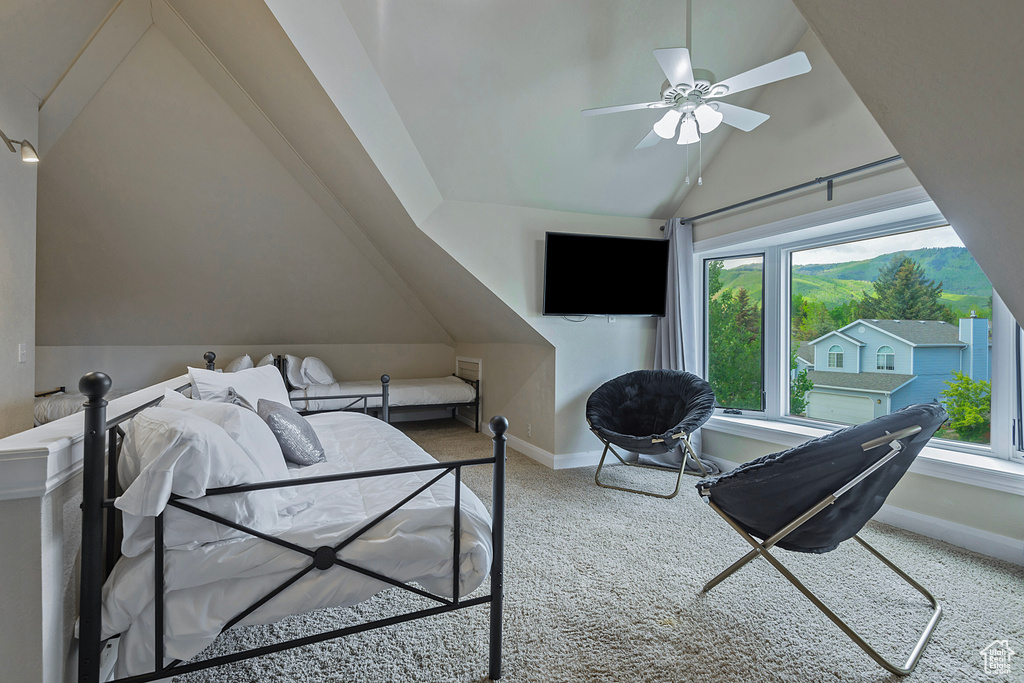 Carpeted bedroom featuring vaulted ceiling and baseboards