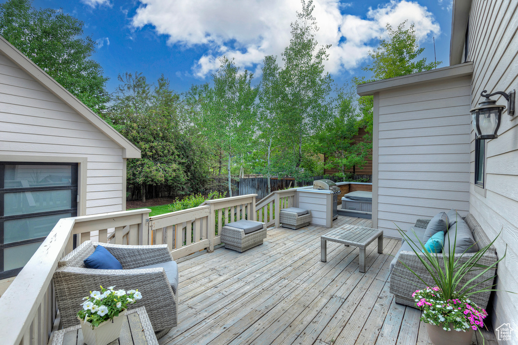 Wooden terrace featuring outdoor lounge area