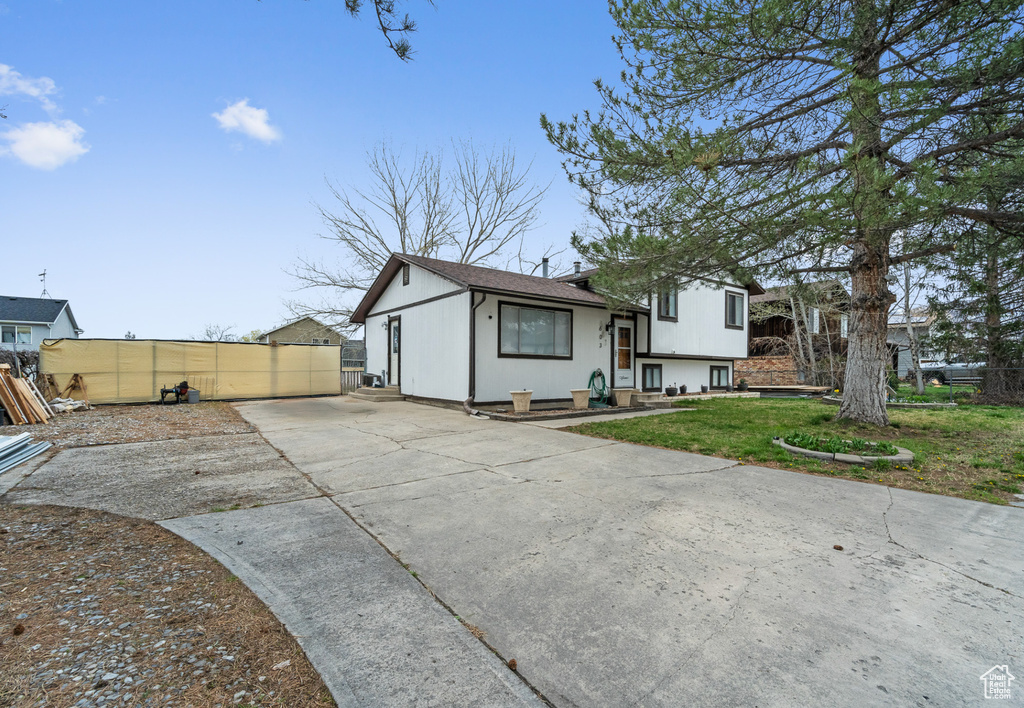 View of front of property featuring concrete driveway