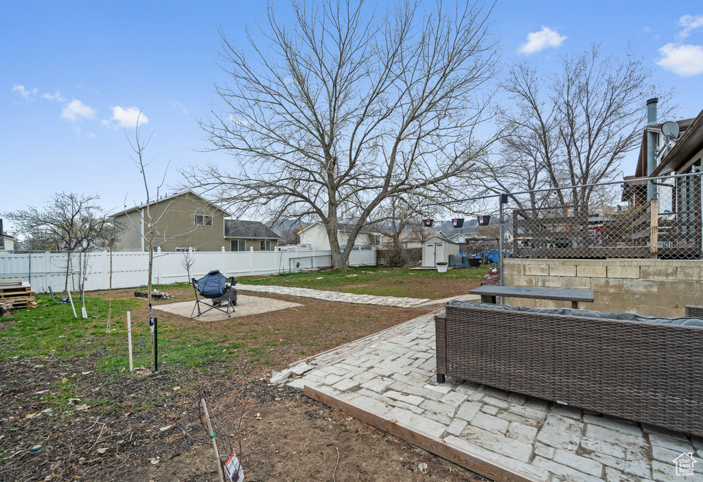 Fenced backyard with a patio area, a residential view, and outdoor lounge area