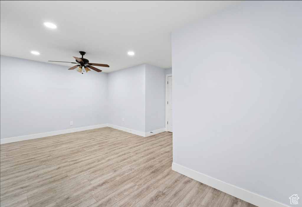 Empty room featuring ceiling fan, baseboards, recessed lighting, and light wood-style floors