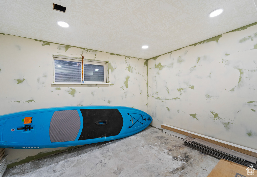 Spare room featuring recessed lighting and unfinished concrete flooring