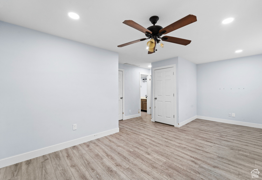 Spare room featuring baseboards, recessed lighting, ceiling fan, and light wood-type flooring
