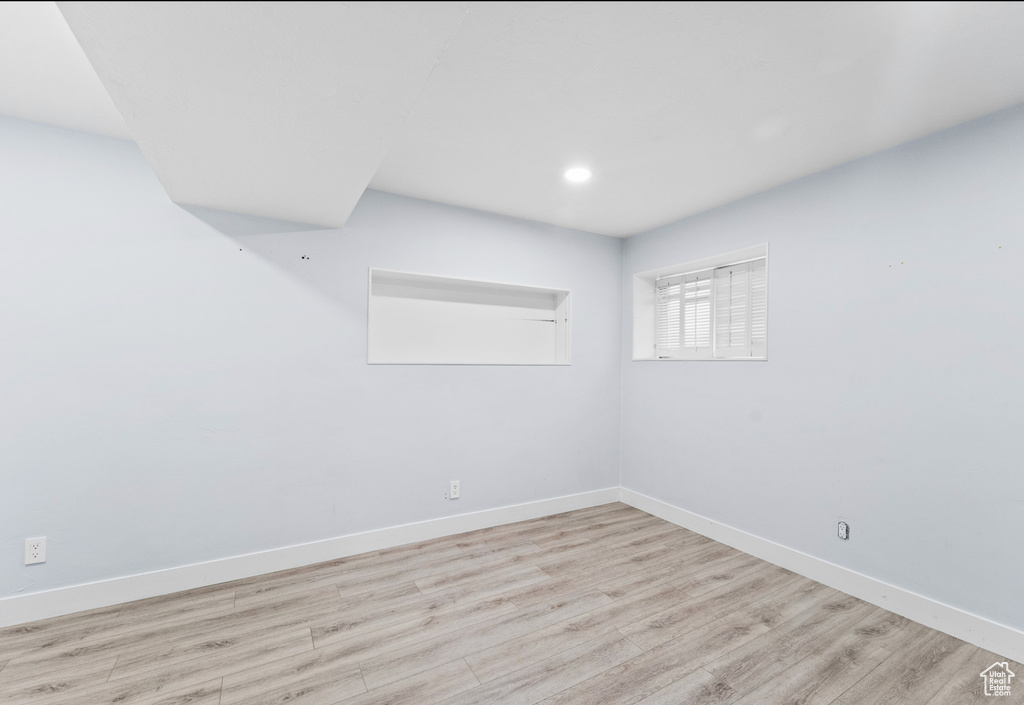 Spare room with wood finished floors, baseboards, and recessed lighting
