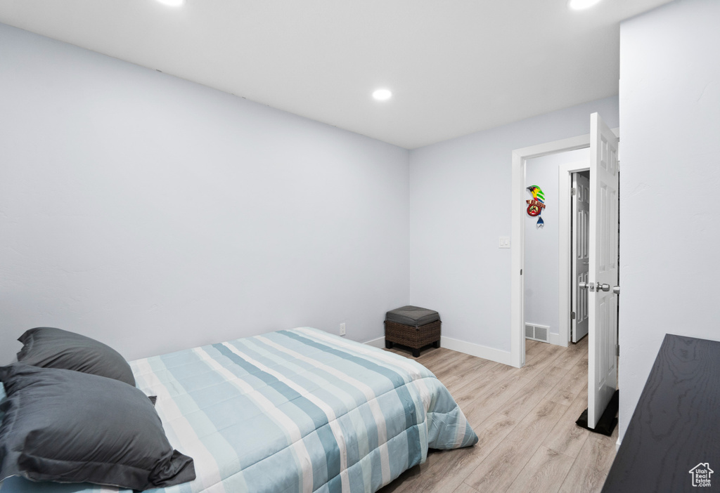 Bedroom with recessed lighting, light wood finished floors, and baseboards