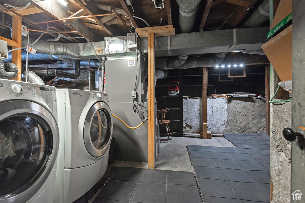 Unfinished basement with washer and clothes dryer