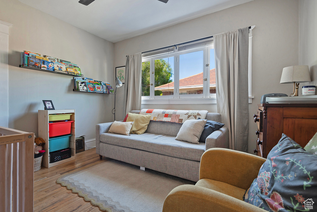 Living room with wood finished floors and a ceiling fan
