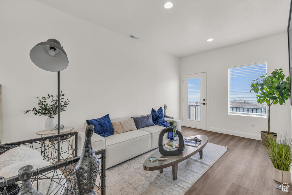 Living room featuring wood finished floors, recessed lighting, and baseboards