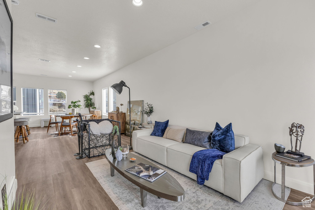 Living area featuring wood finished floors, recessed lighting, and baseboards
