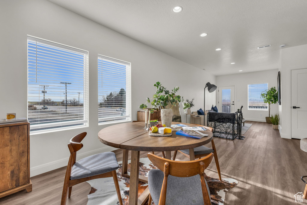 Dining space featuring wood finished floors, recessed lighting, and baseboards