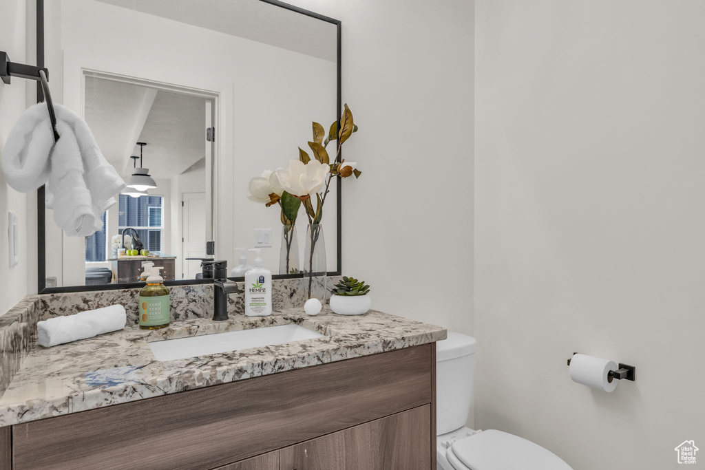 Half bath featuring vanity and toilet