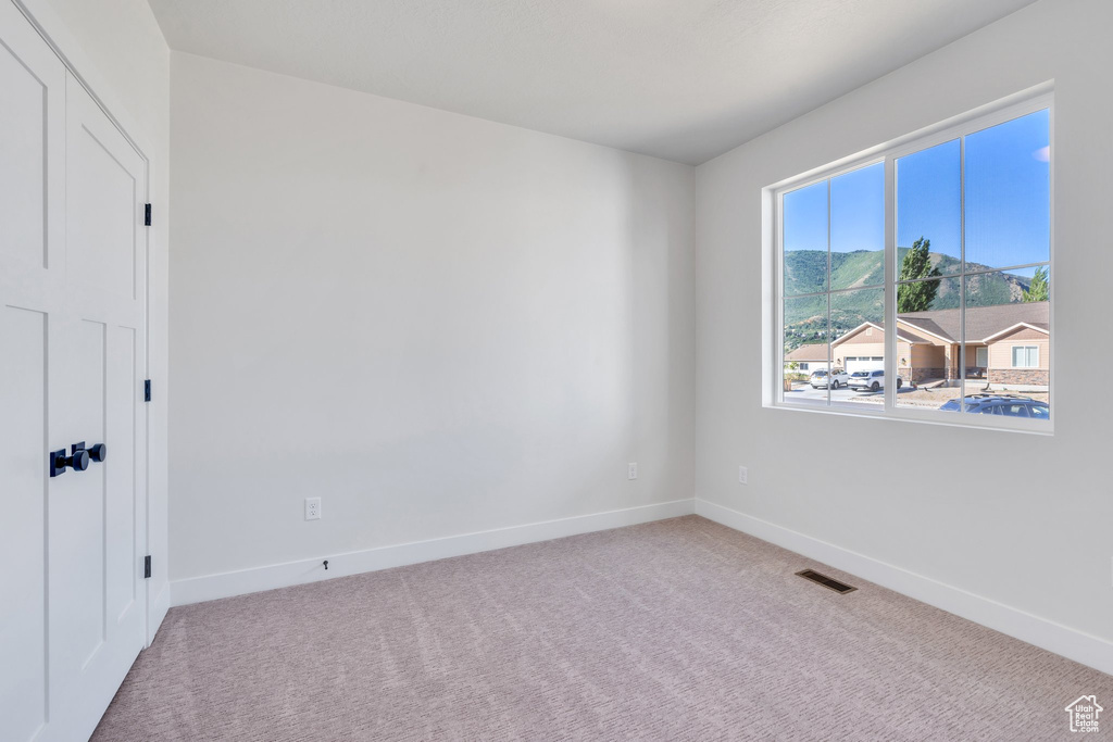 Unfurnished room featuring baseboards and carpet flooring