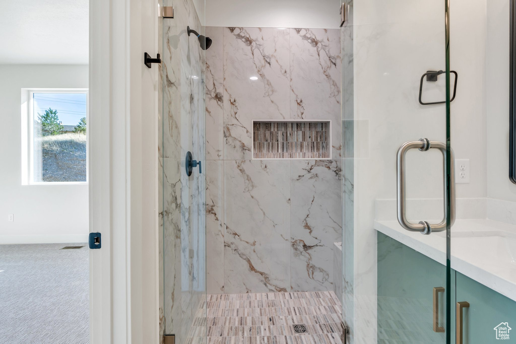Bathroom featuring a marble finish shower