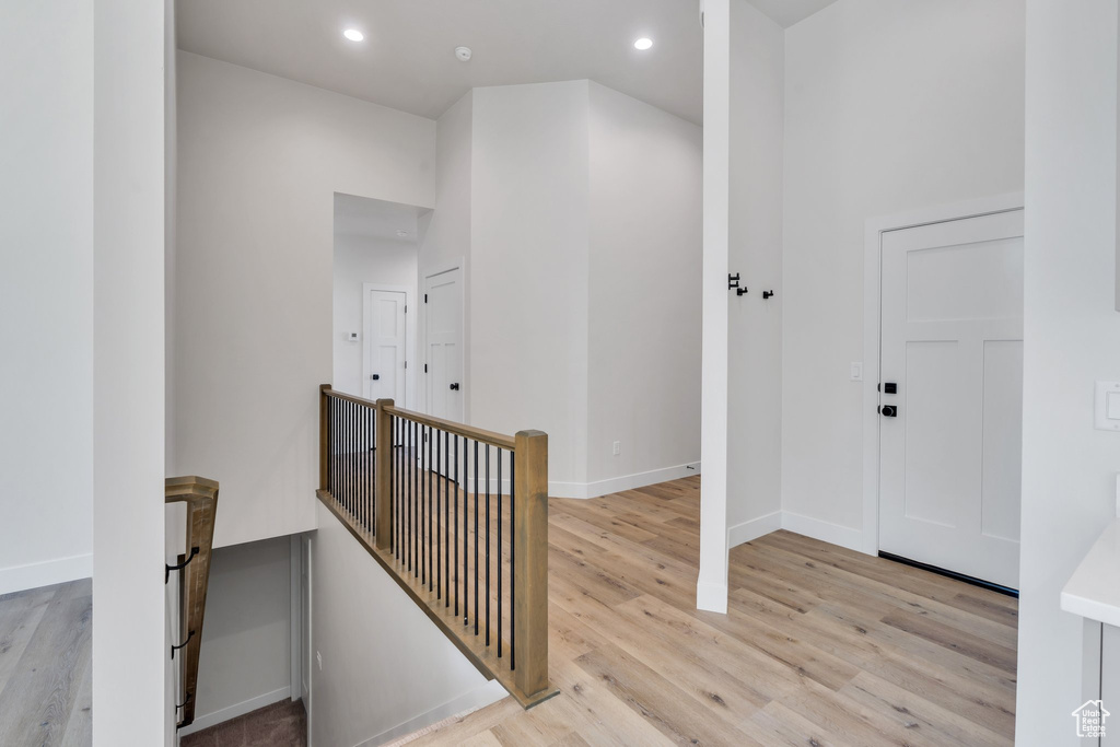 Entryway with light wood-type flooring and recessed lighting
