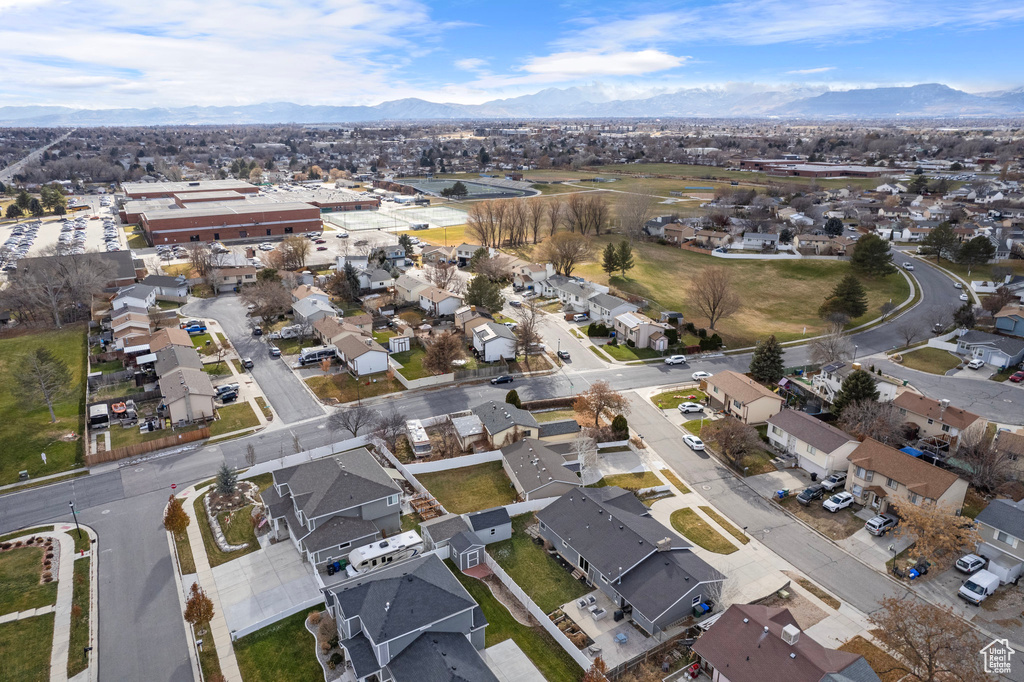Aerial view of property's location with nearby suburban area and a mountain backdrop