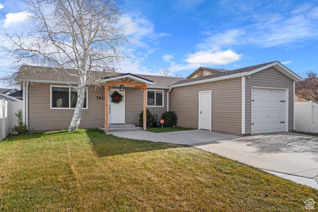 Single story home with an attached garage, driveway, and roof with shingles