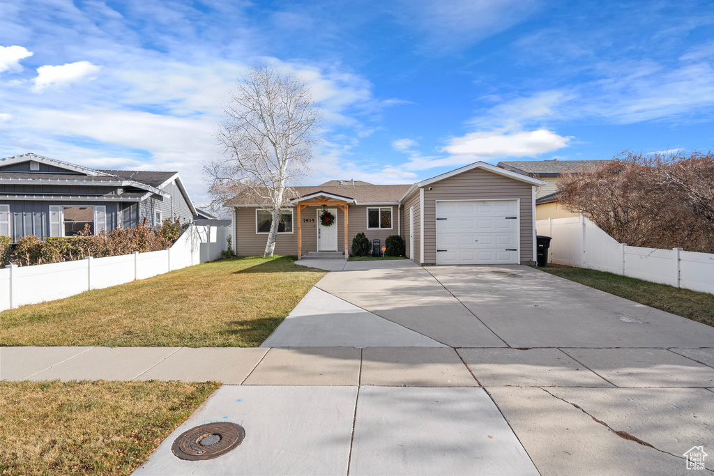 Ranch-style home featuring driveway and an attached garage
