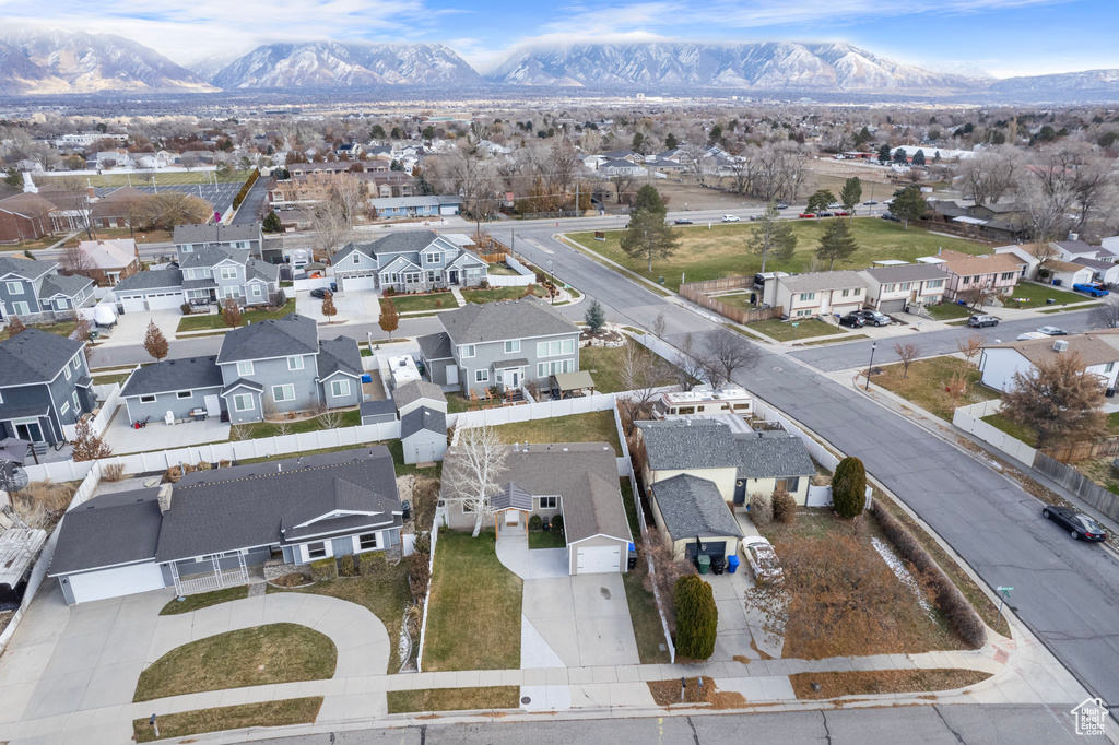 Aerial view of residential area featuring a mountainous background