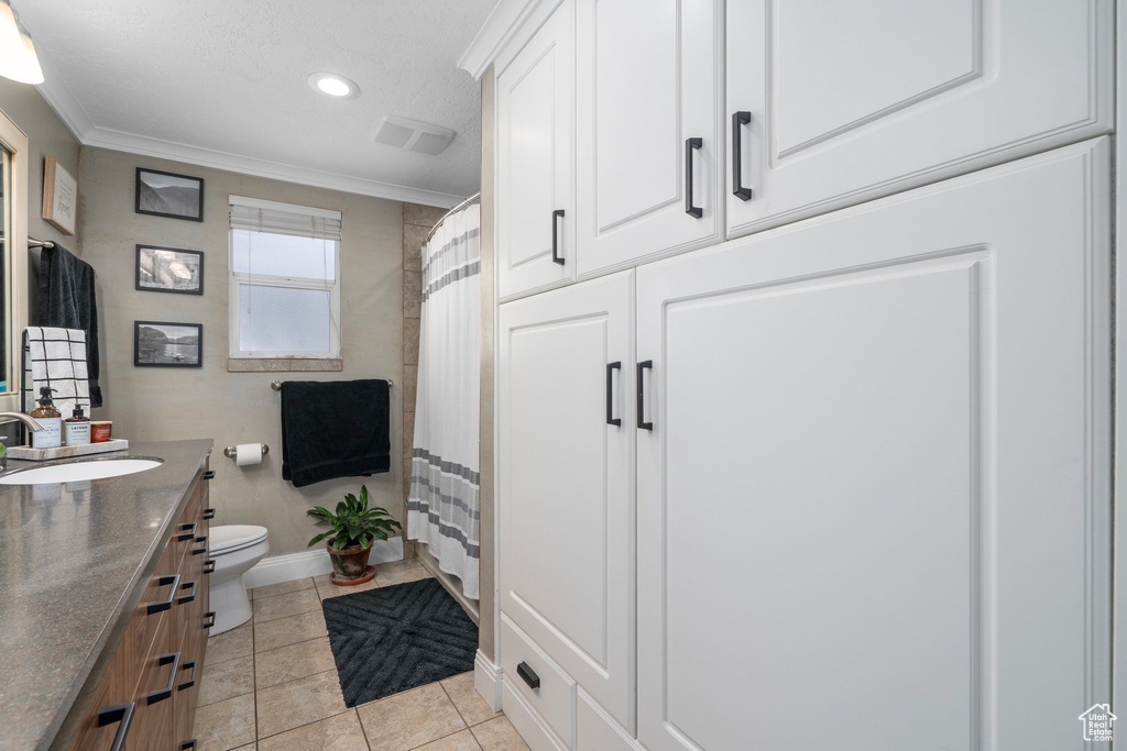 Full bathroom with vanity, toilet, crown molding, tile patterned flooring, and recessed lighting
