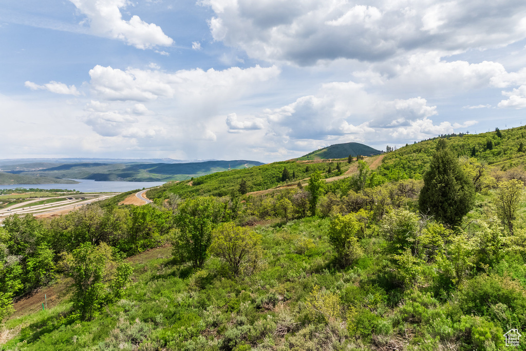 View of mountain backdrop featuring a nearby body of water