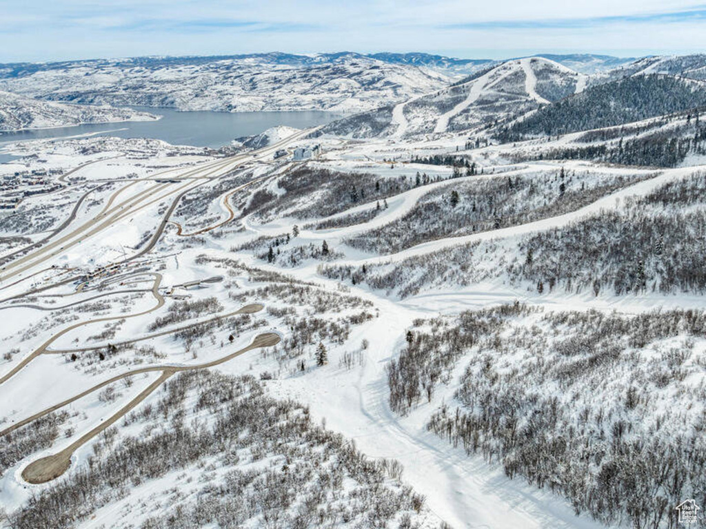Snowy aerial view featuring a mountain view