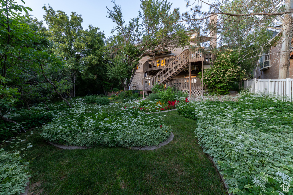 View of yard with stairs and a wooden deck