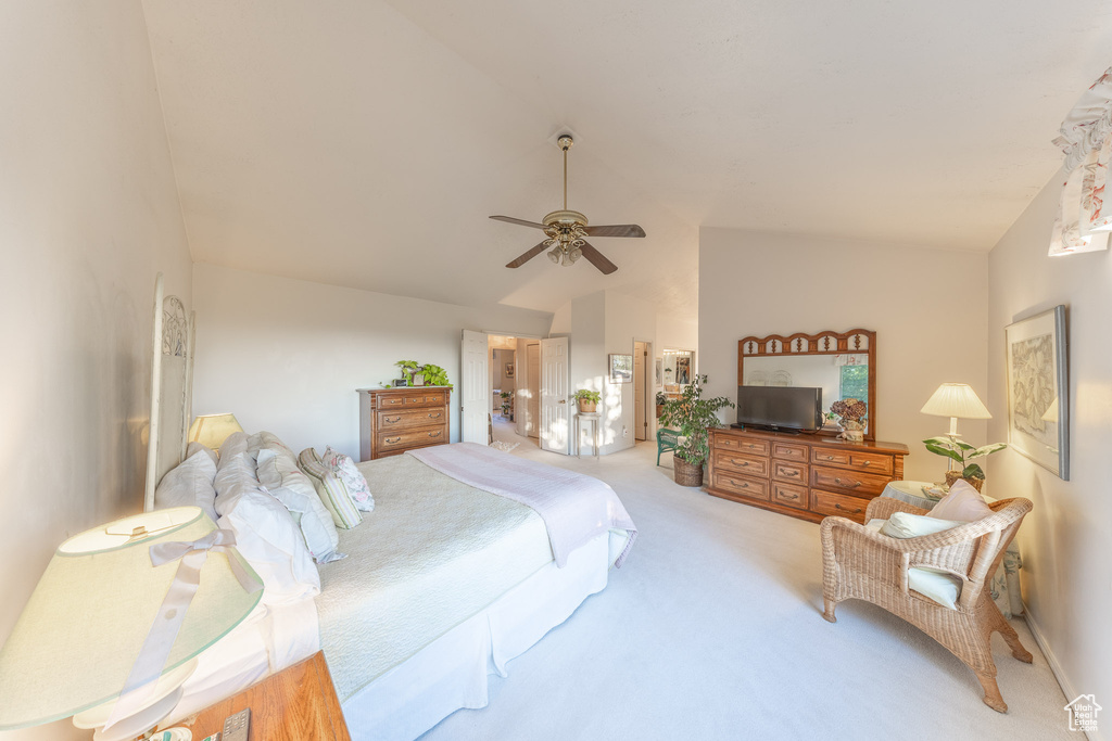 Bedroom featuring vaulted ceiling, carpet flooring, and a ceiling fan