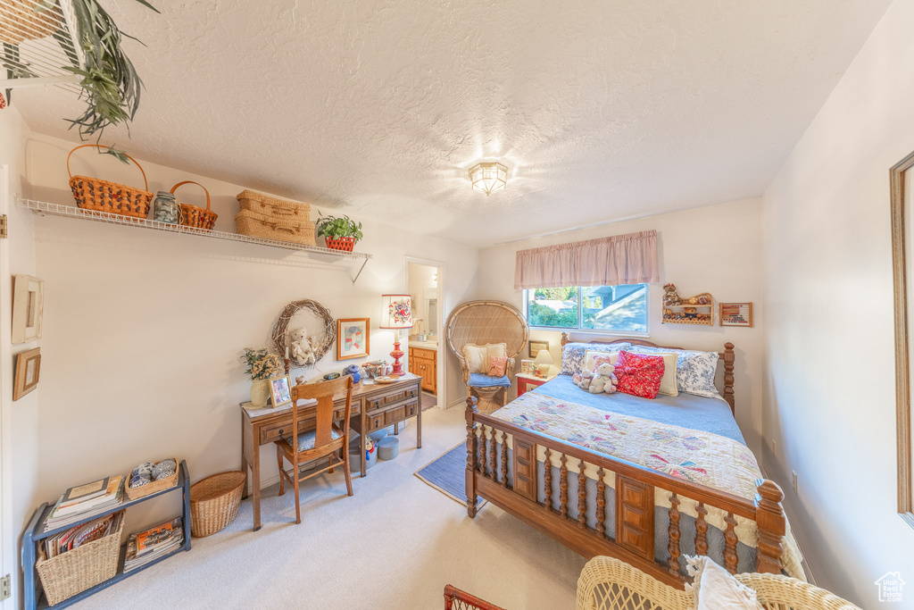 Carpeted bedroom featuring a textured ceiling