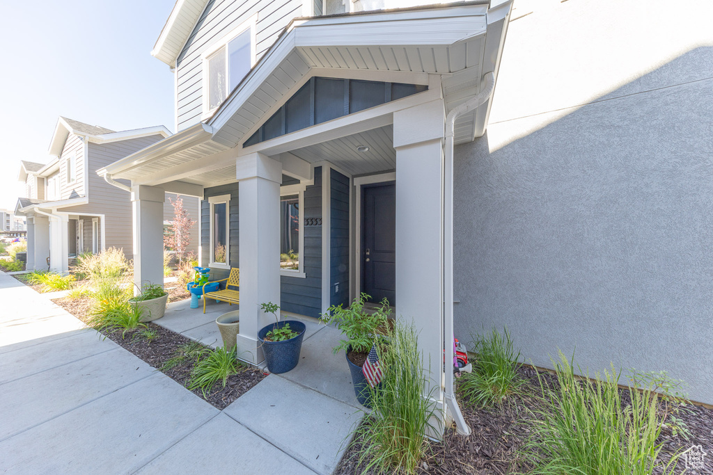 Entrance to property featuring covered porch and board and batten siding