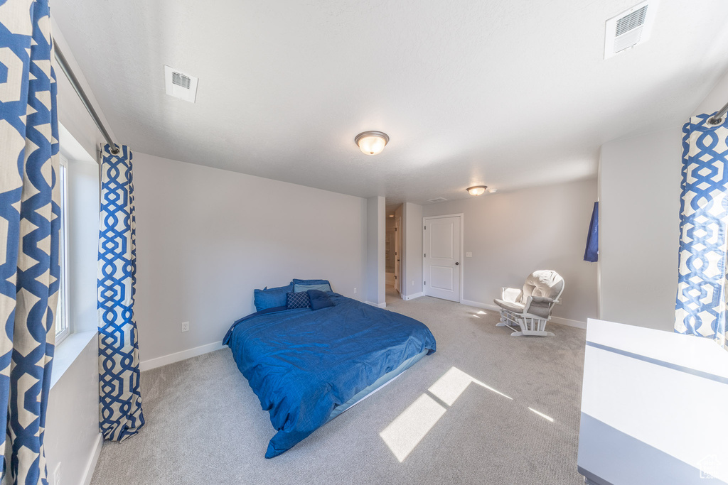 Carpeted bedroom with baseboards