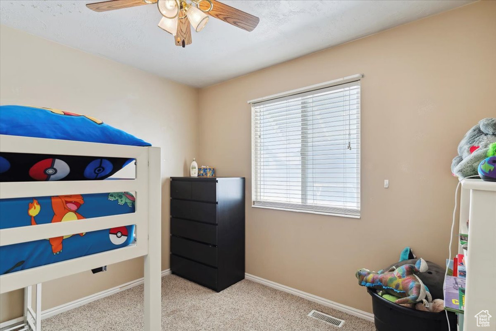 Bedroom with carpet, baseboards, and a ceiling fan