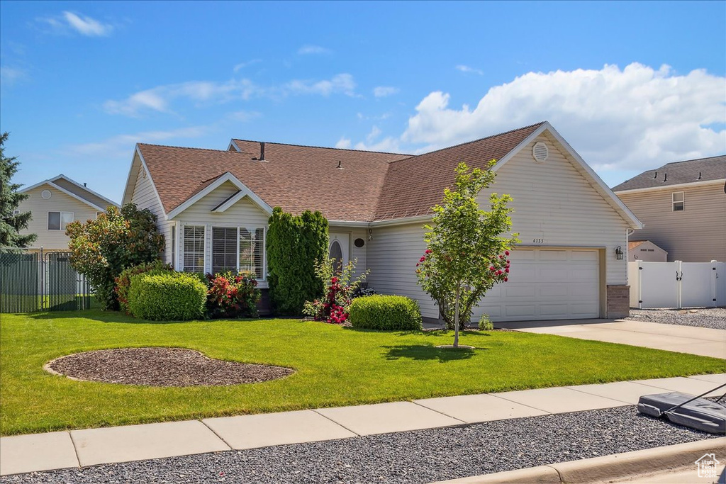 View of front facade with an attached garage, concrete driveway, and a shingled roof