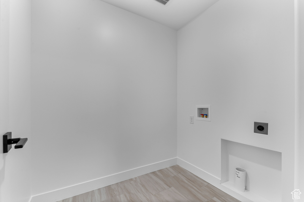 Laundry room featuring hookup for an electric dryer, hookup for a washing machine, and baseboards
