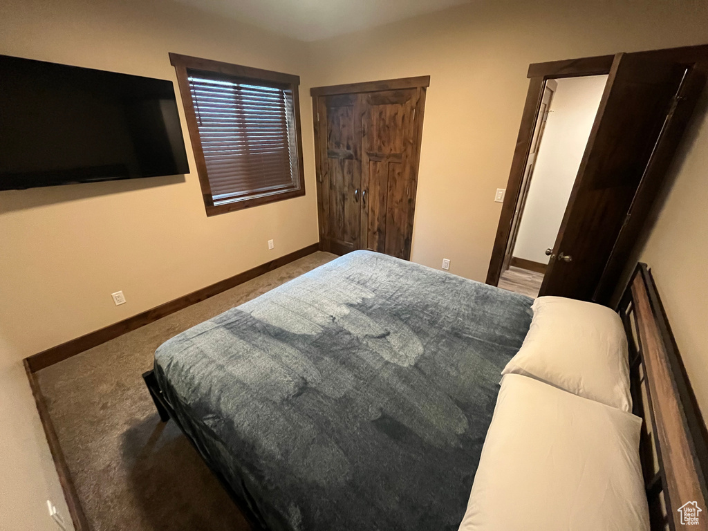 Bedroom with baseboards and carpet flooring
